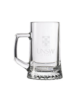 Glass beer mug with an engraved UNSW logo
